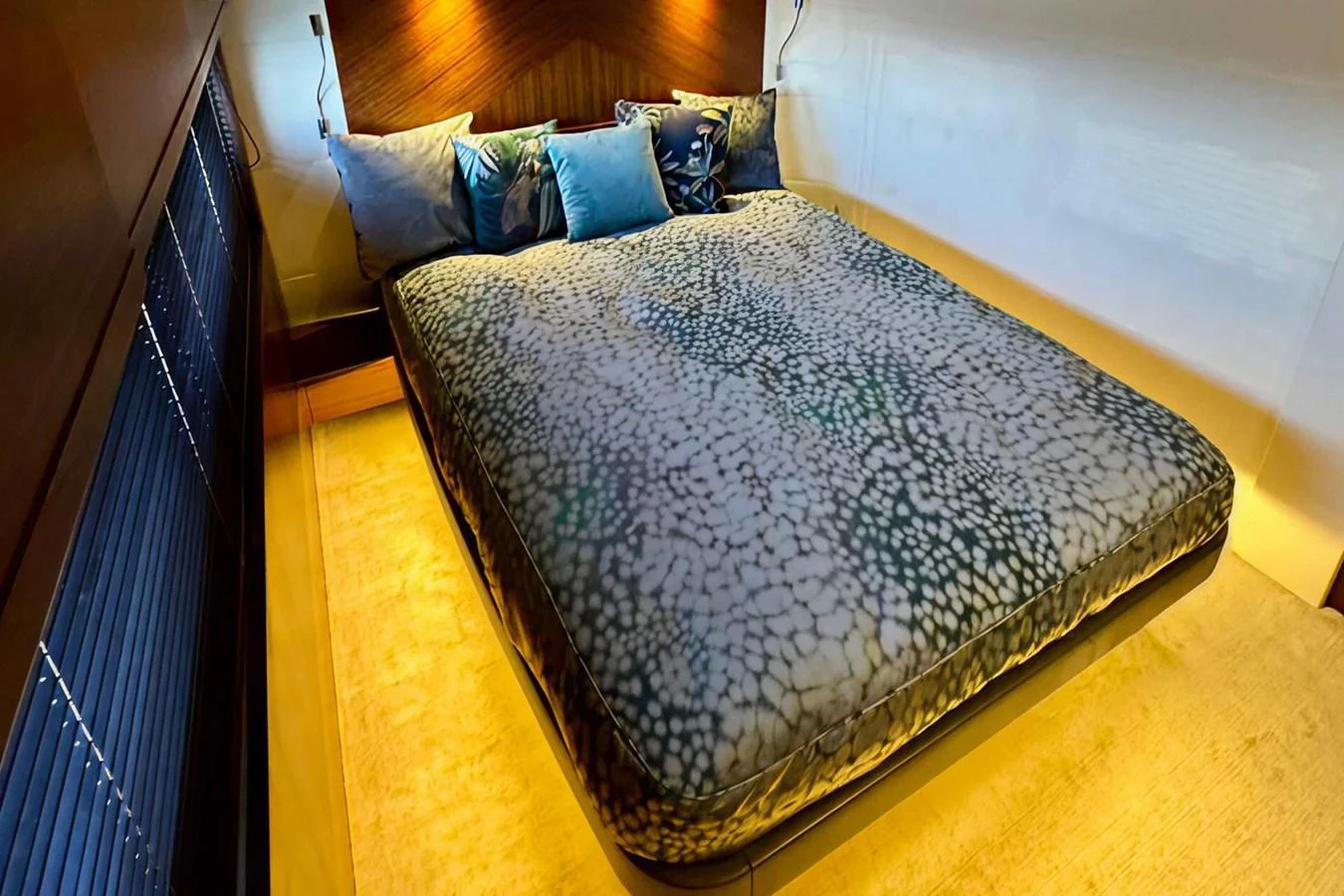 A luxurious stateroom featuring a plush bed with elegant bedding and ambient lighting. aboard LADY N Yacht for Sale