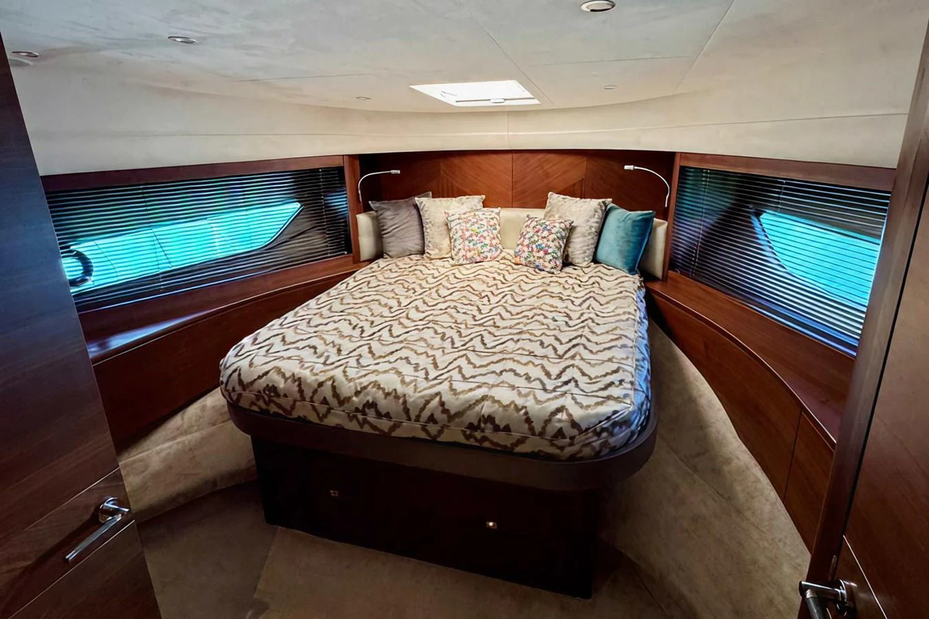 The master stateroom features a spacious bed with elegant bedding and ample natural light from the side windows. aboard LADY N Yacht for Sale