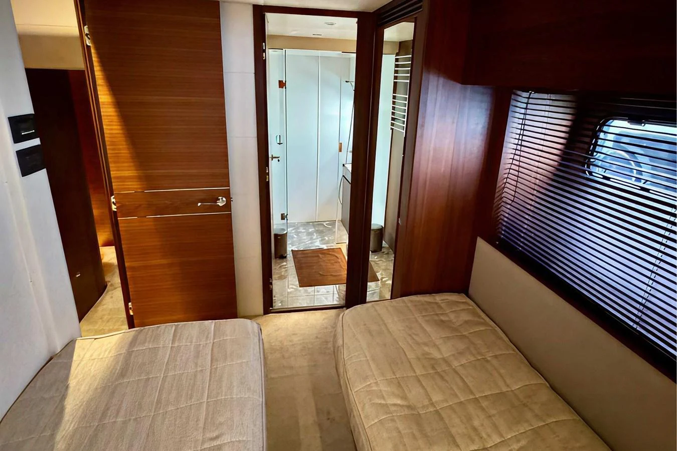 The guest stateroom features twin beds and a view into the ensuite bathroom. aboard LADY N Yacht for Sale