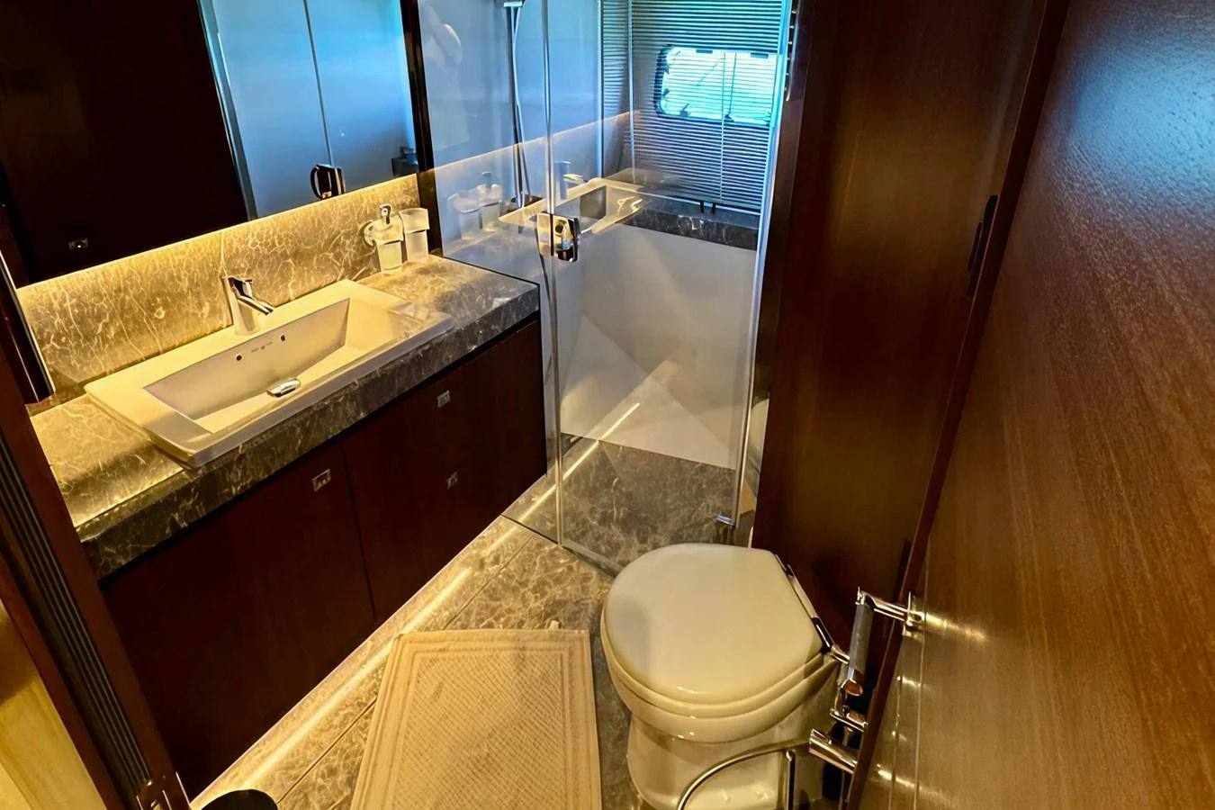 The yacht's bathroom features elegant fixtures and a modern design with a glass-enclosed shower. aboard LADY N Yacht for Sale