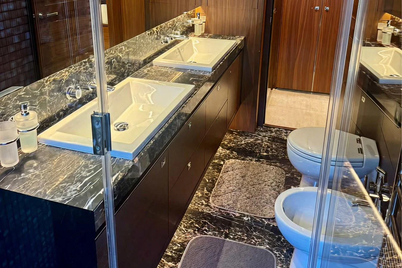 The yacht's bathroom features a luxurious double sink vanity with elegant marble countertops and modern fixtures. aboard LADY N Yacht for Sale