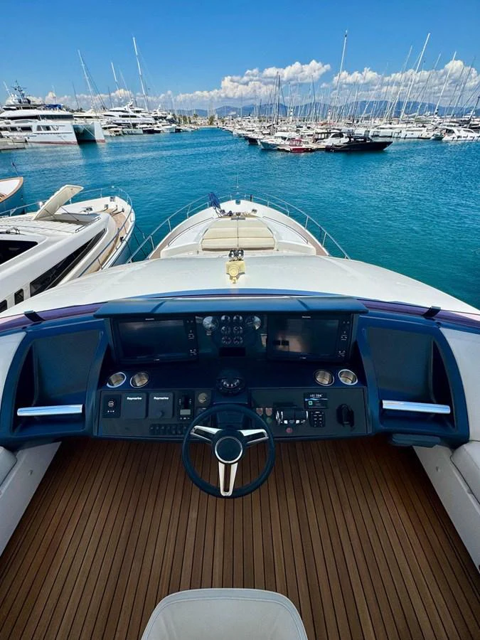The helm station offers a commanding view of the marina, with sleek controls and a comfortable seating area. aboard LADY N Yacht for Sale