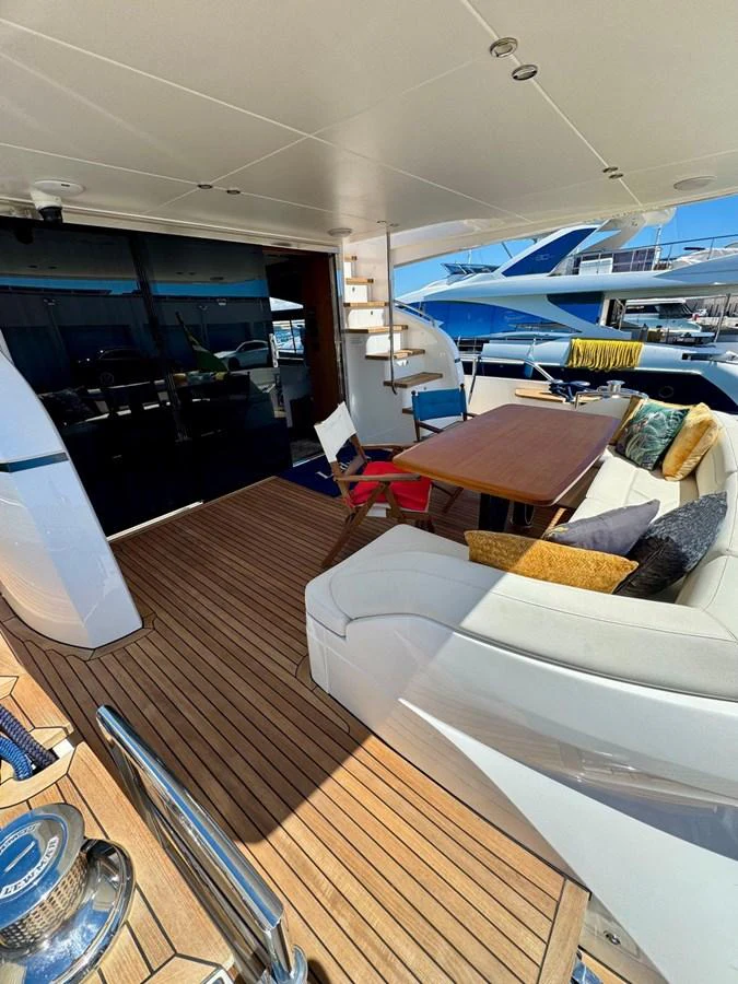 The aft deck features a comfortable seating area with a dining table, perfect for alfresco meals. aboard LADY N Yacht for Sale
