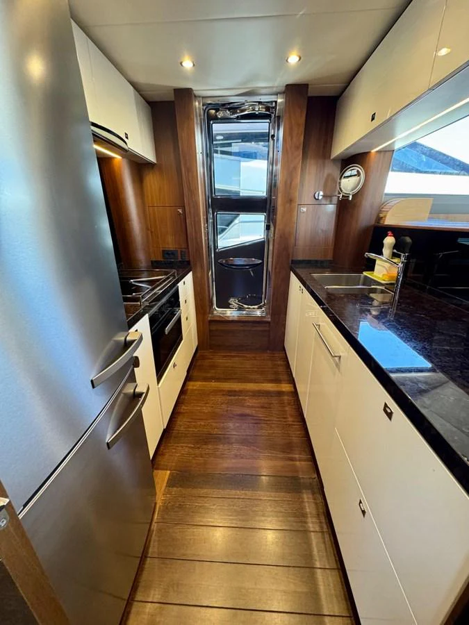 The yacht's galley is equipped with modern appliances and sleek countertops, offering a functional and stylish cooking space. aboard LADY N Yacht for Sale