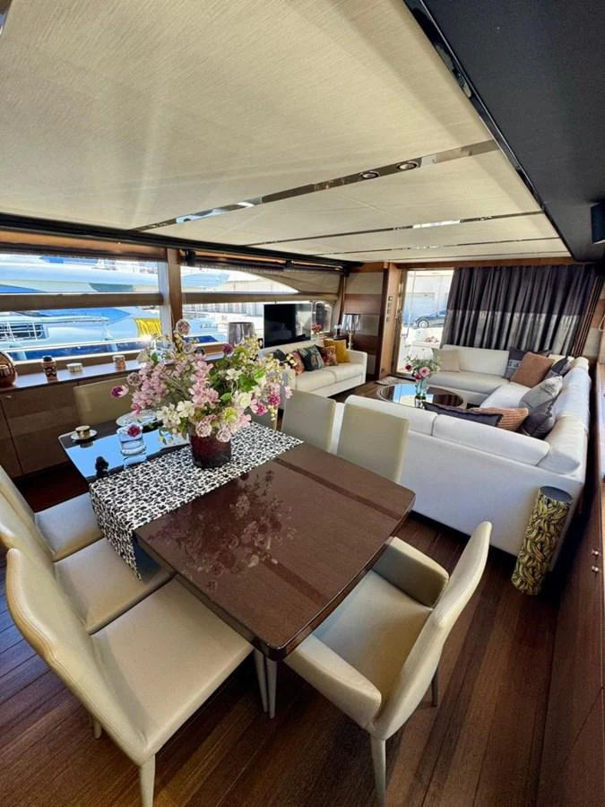 The salon offers a spacious and elegant seating area with a dining table and plush sofas. aboard LADY N Yacht for Sale