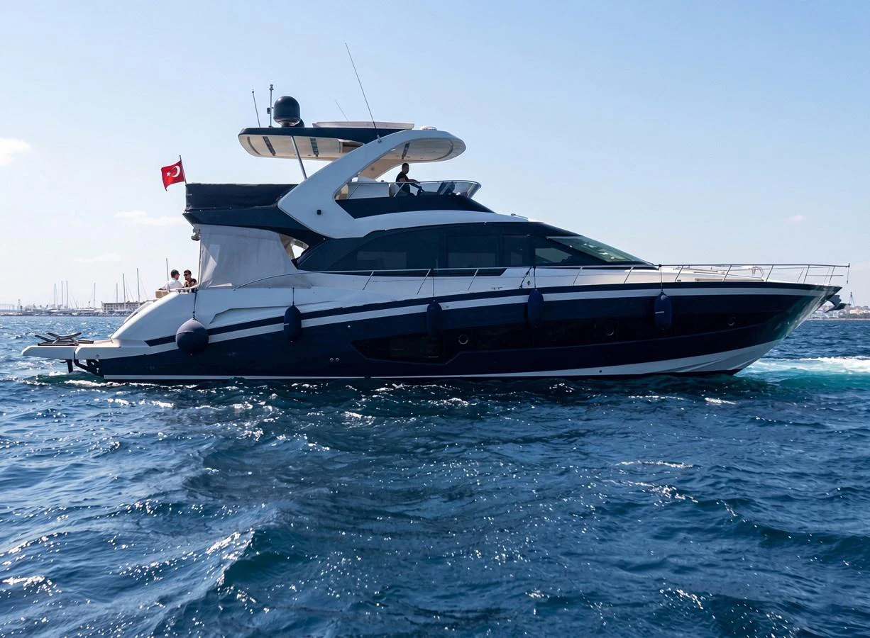 A sleek and modern yacht cruising on the open water under a clear sky. aboard ASB Yacht for Sale