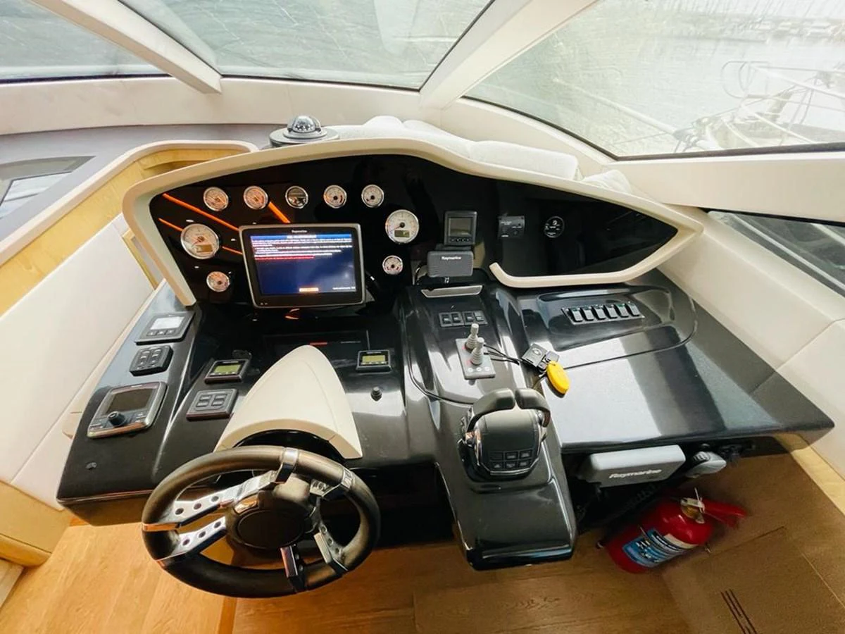 The helm station features advanced navigation equipment and a sleek, modern design. aboard ASB Yacht for Sale