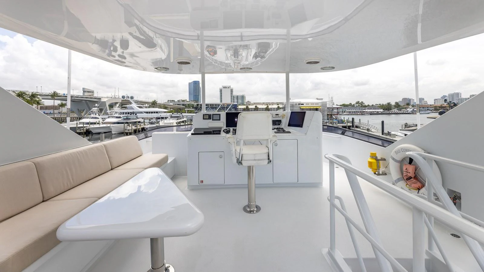 The helm area features a sleek, modern design with ample seating and advanced navigation equipment. aboard BAD COMPANY Yacht for Sale
