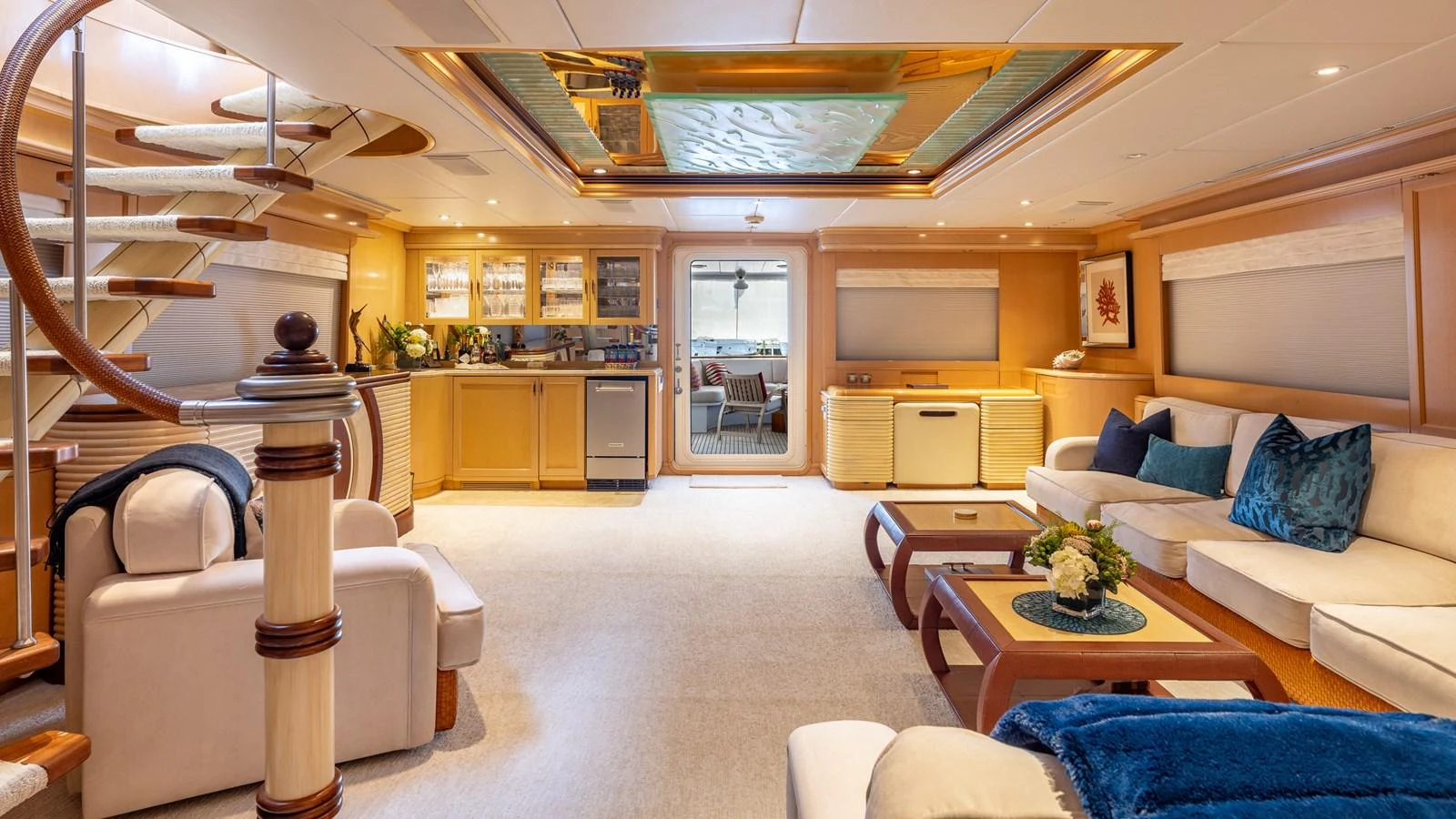 The salon features luxurious seating, a stylish staircase, and a well-equipped bar area, creating an inviting and elegant atmosphere. aboard BAD COMPANY Yacht for Sale