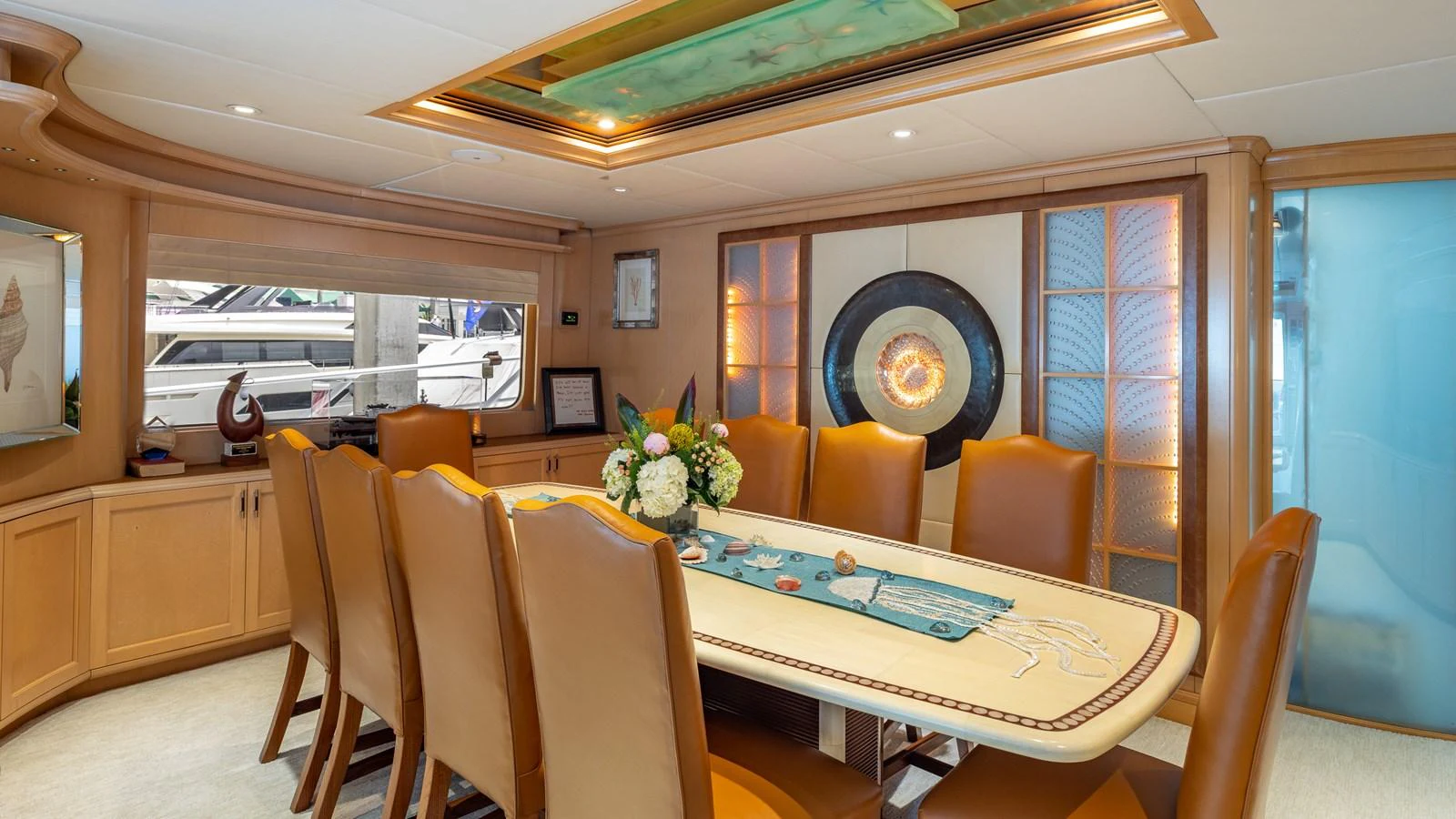 The yacht's dining area features a stylish table with comfortable seating and elegant decor. aboard BAD COMPANY Yacht for Sale