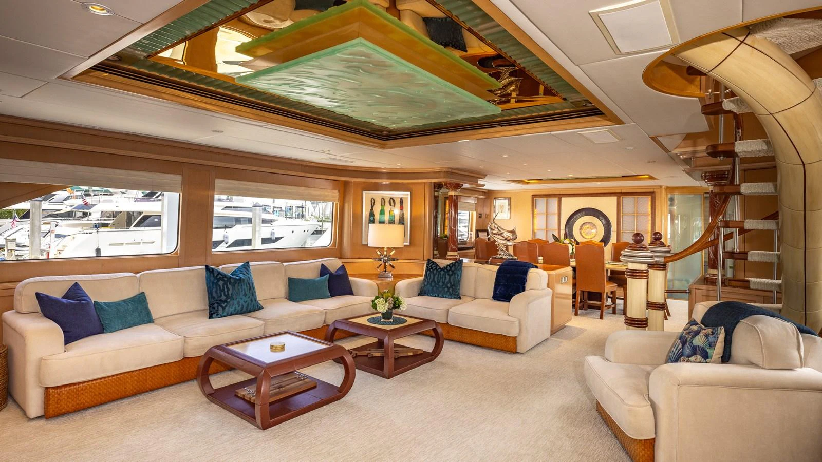 The salon features luxurious seating with elegant decor and ample natural light. aboard BAD COMPANY Yacht for Sale