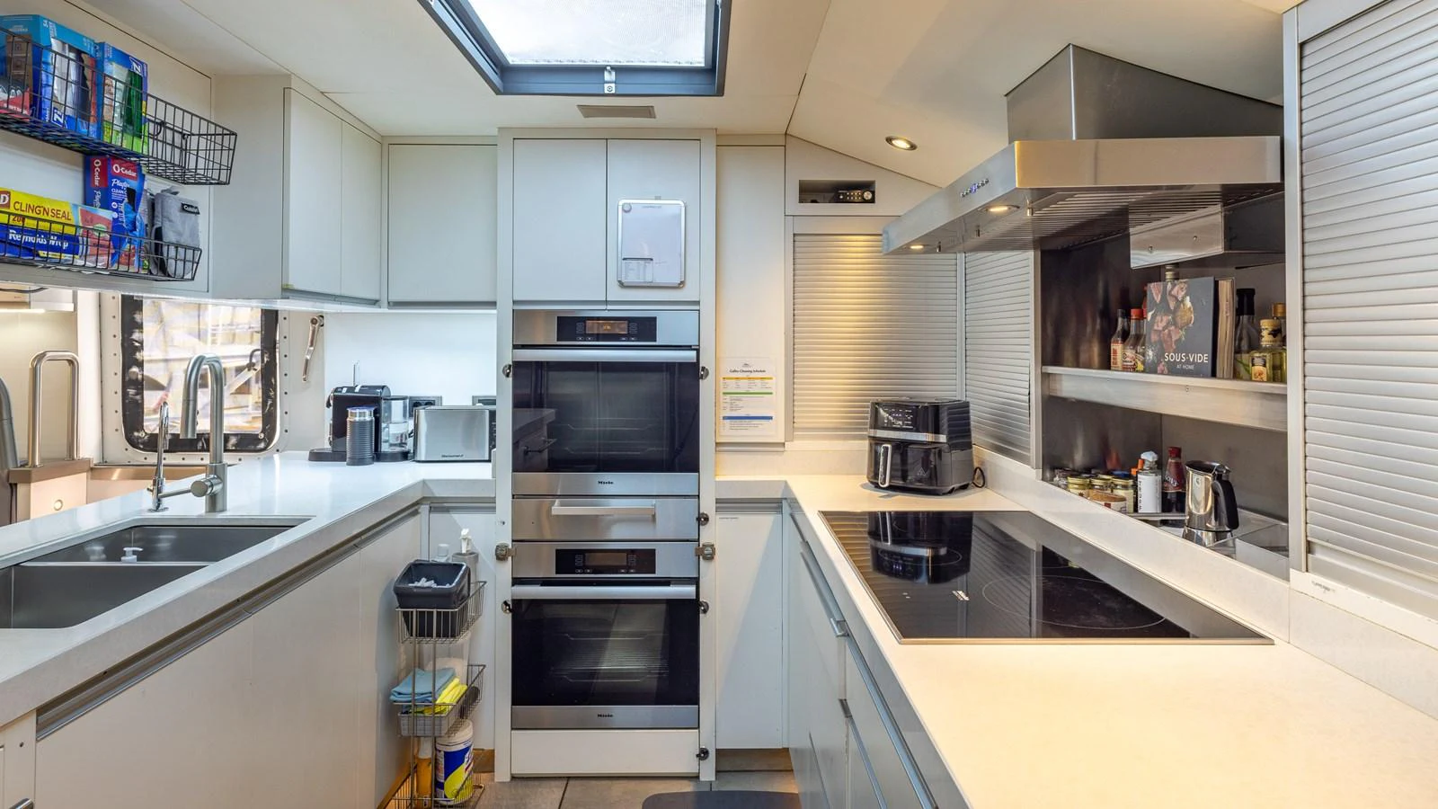 The yacht's galley is equipped with modern appliances and ample counter space, perfect for gourmet meal preparation. aboard BAD COMPANY Yacht for Sale