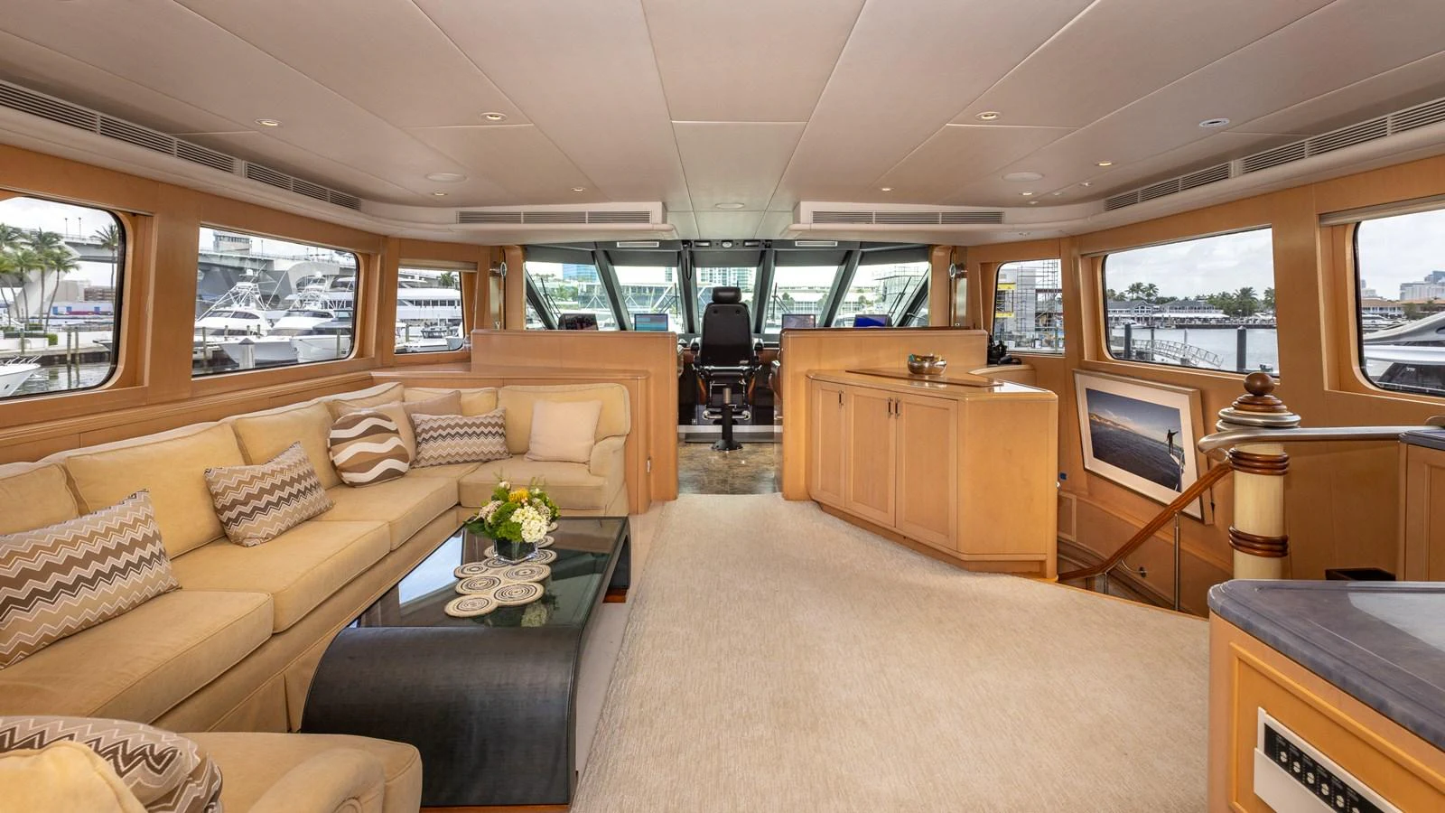 The salon features plush seating, elegant decor, and panoramic windows offering stunning views. aboard BAD COMPANY Yacht for Sale
