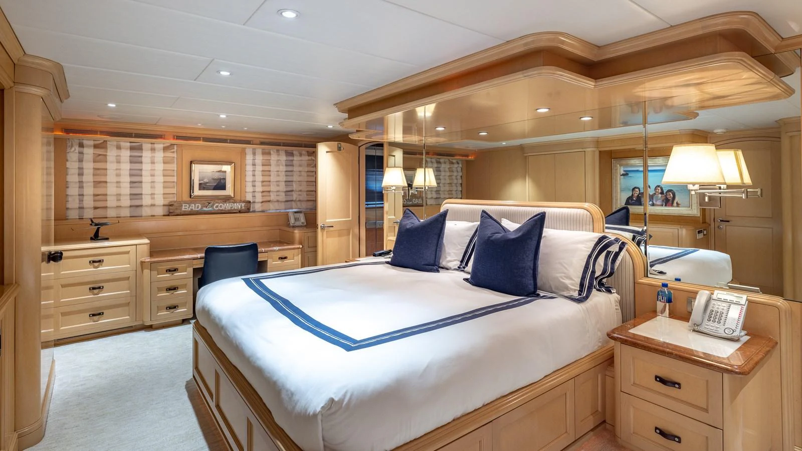 The master stateroom features a luxurious bed with elegant bedding and ample storage space. aboard BAD COMPANY Yacht for Sale