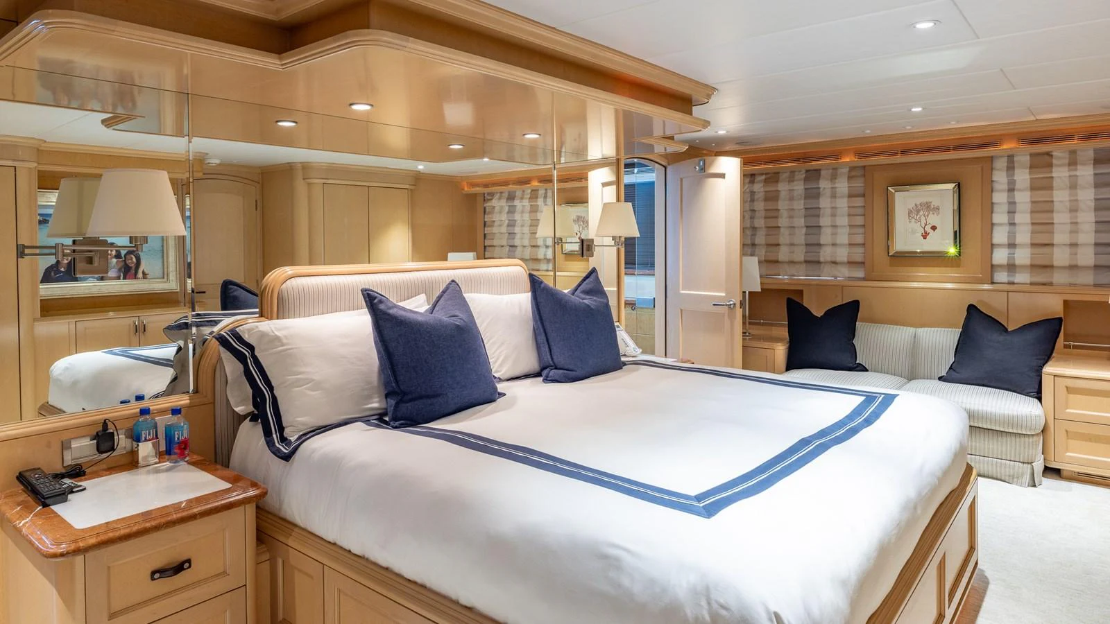 The master stateroom features a luxurious bed with elegant bedding and ample natural light. aboard BAD COMPANY Yacht for Sale