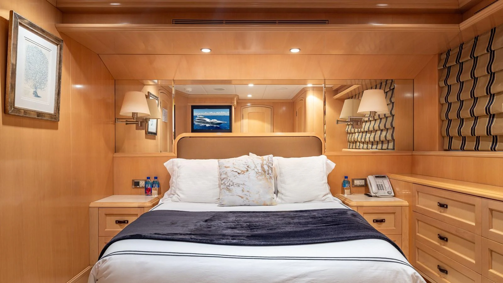 The master stateroom features a luxurious bed with elegant wood paneling and modern amenities. aboard BAD COMPANY Yacht for Sale