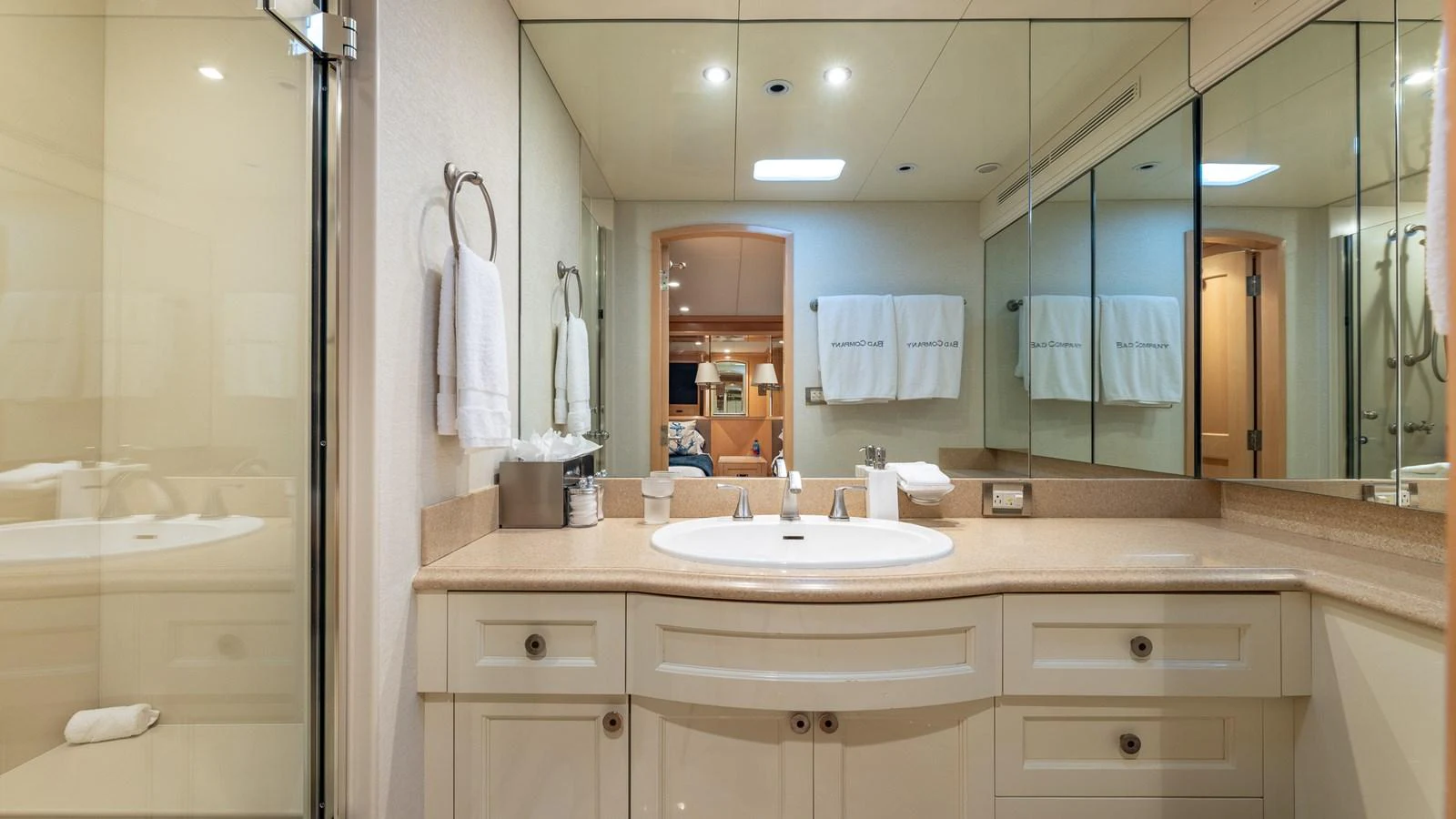 The yacht's bathroom features a spacious vanity with ample storage and a large mirror. aboard BAD COMPANY Yacht for Sale