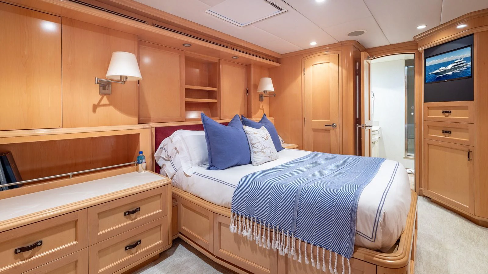 The master stateroom features a luxurious bed with plush pillows and elegant wooden cabinetry. aboard BAD COMPANY Yacht for Sale