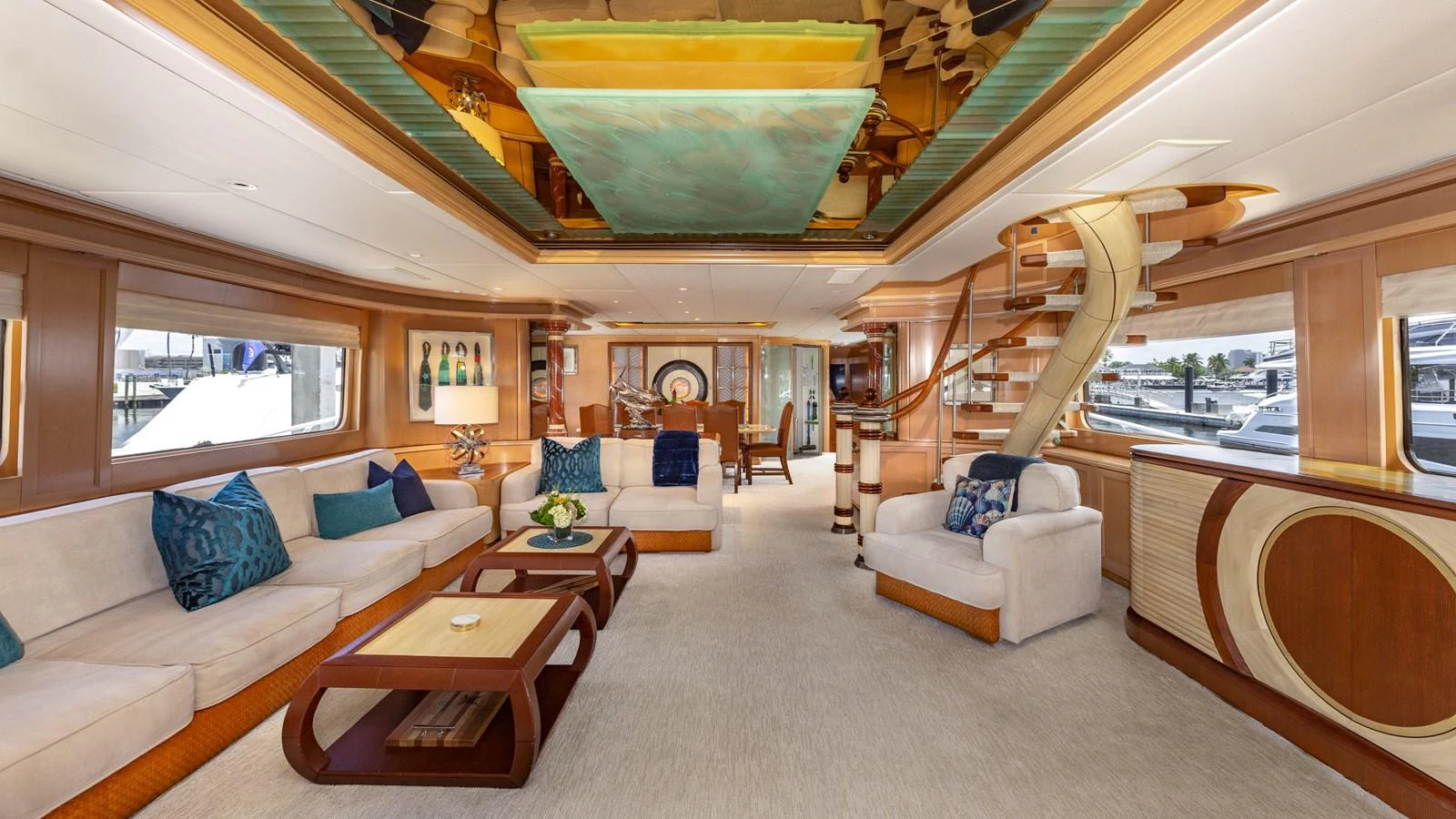 The salon features luxurious seating, elegant decor, and ample natural light. aboard BAD COMPANY Yacht for Sale