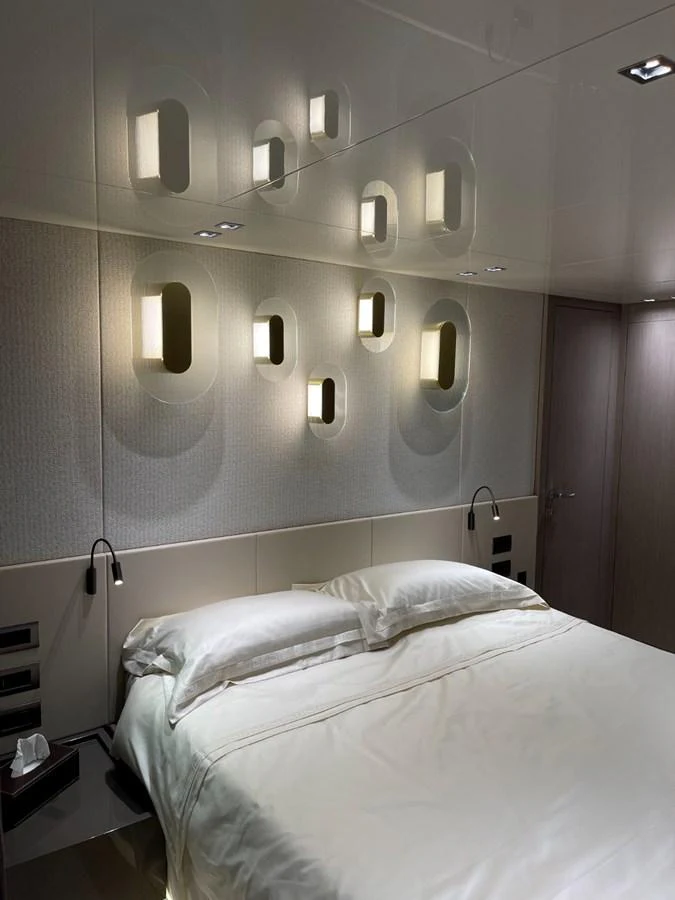 A luxurious stateroom featuring modern lighting and a comfortable bed. aboard FOUZ Yacht for Sale