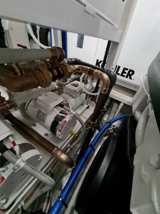 The image showcases the intricate details of the yacht's engine room, highlighting the mechanical components and piping. aboard FOUZ Yacht for Sale