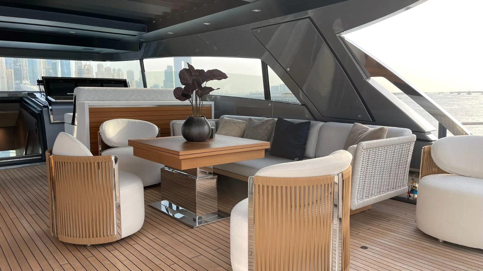 The aft deck features a stylish seating area with modern furnishings and a scenic view. aboard FOUZ Yacht for Sale