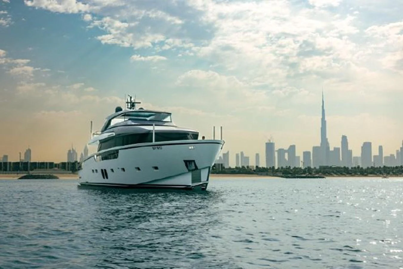 A sleek yacht cruises gracefully with a stunning city skyline in the background. aboard FOUZ Yacht for Sale