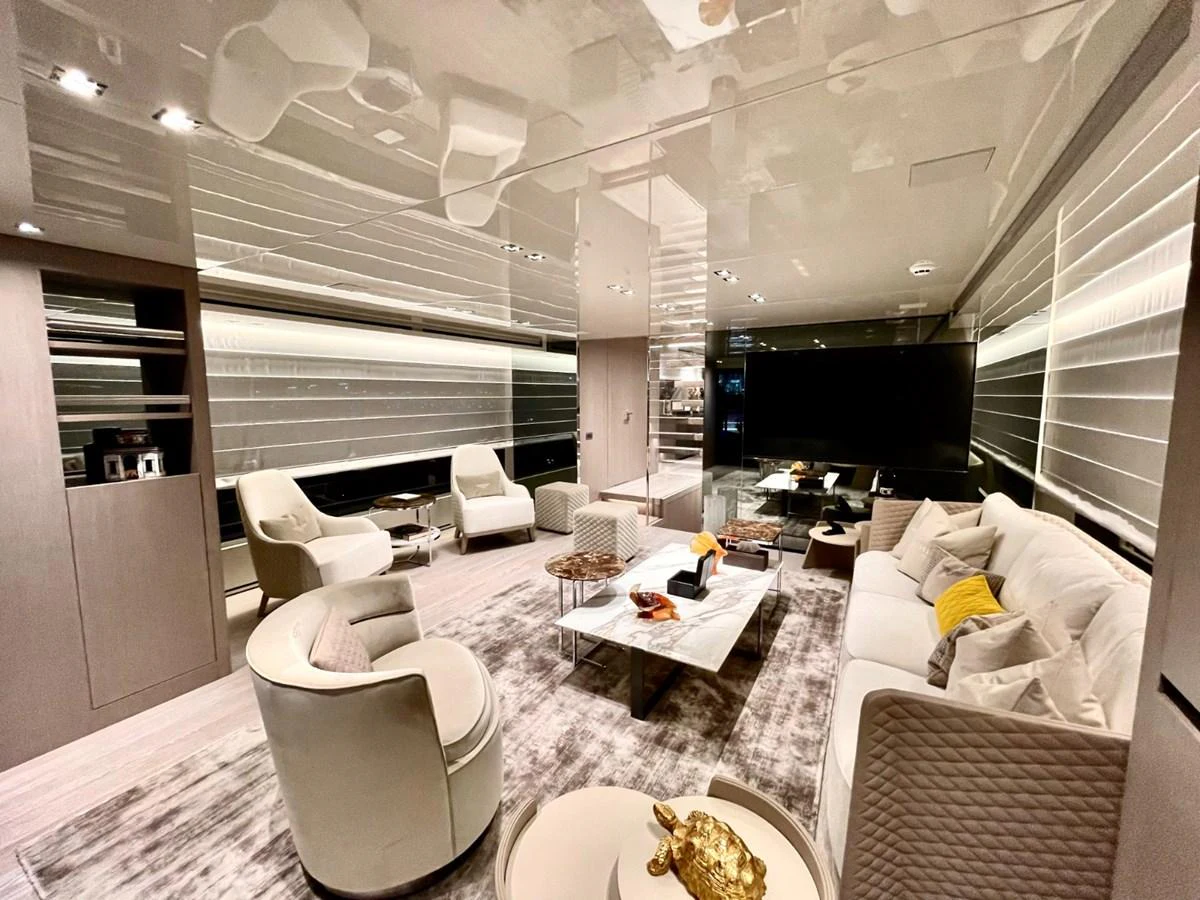 The yacht's interior features a luxurious and modern living area with plush seating and elegant decor. aboard FOUZ Yacht for Sale