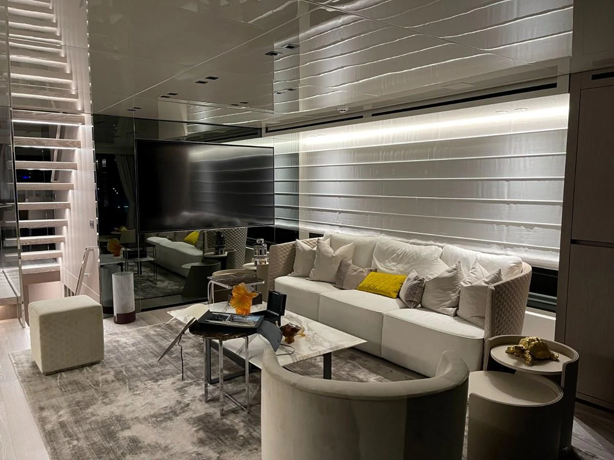 The salon features a modern and luxurious seating area with a large TV and elegant decor. aboard FOUZ Yacht for Sale
