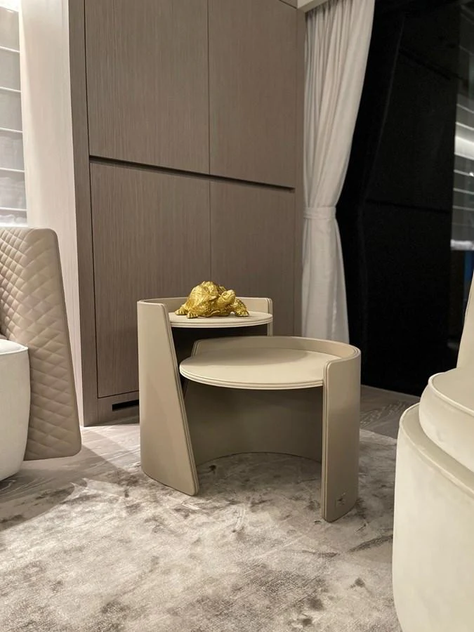 A stylish interior corner featuring a modern side table with a decorative golden object. aboard FOUZ Yacht for Sale