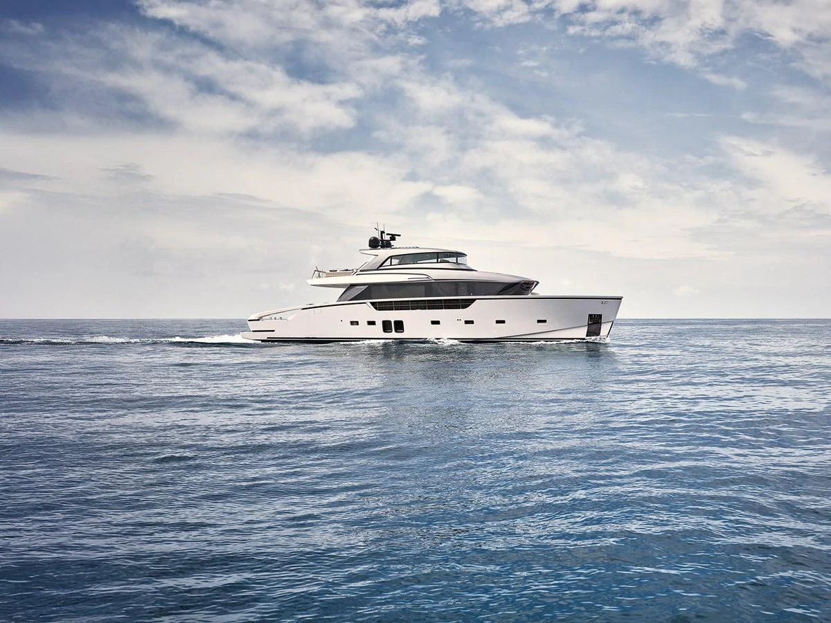 A sleek and modern yacht cruises gracefully on calm waters under a partly cloudy sky. aboard FOUZ Yacht for Sale