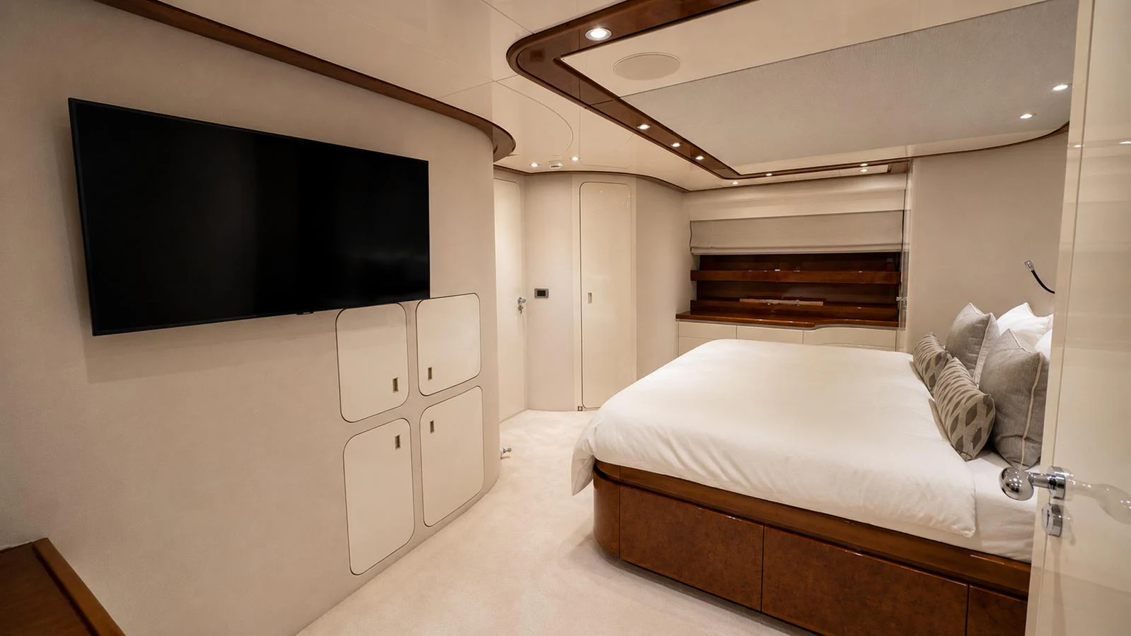 A luxurious stateroom featuring a large bed, modern decor, and a flat-screen TV. aboard ALPHERATZ Yacht for Sale
