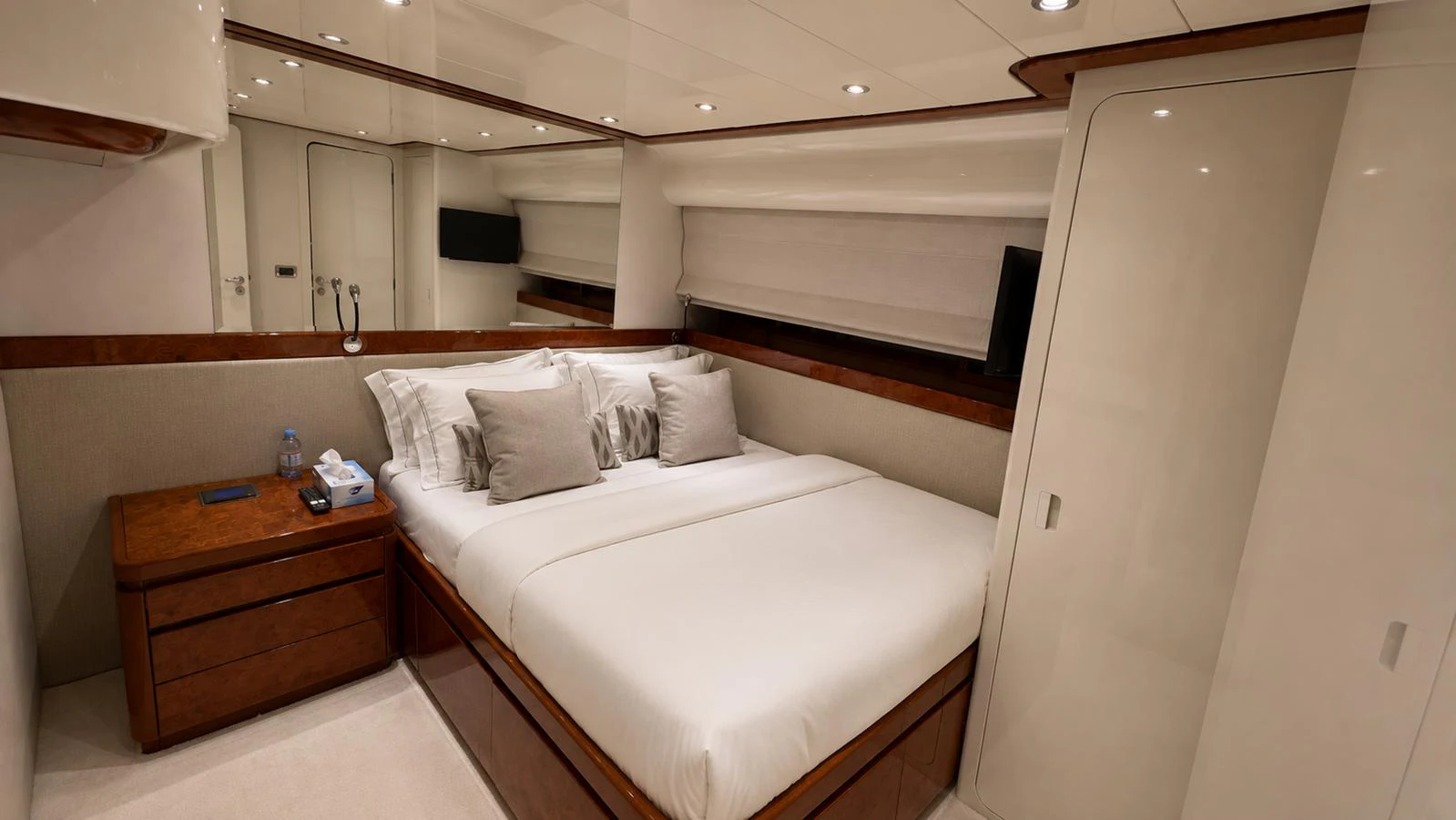 A cozy stateroom with a plush double bed and elegant wooden accents. aboard ALPHERATZ Yacht for Sale