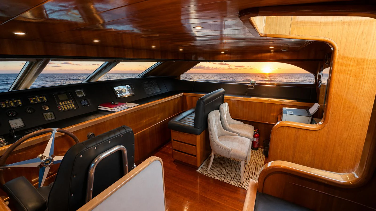 The helm features luxurious wood finishes and a panoramic view of the ocean. aboard ALPHERATZ Yacht for Sale