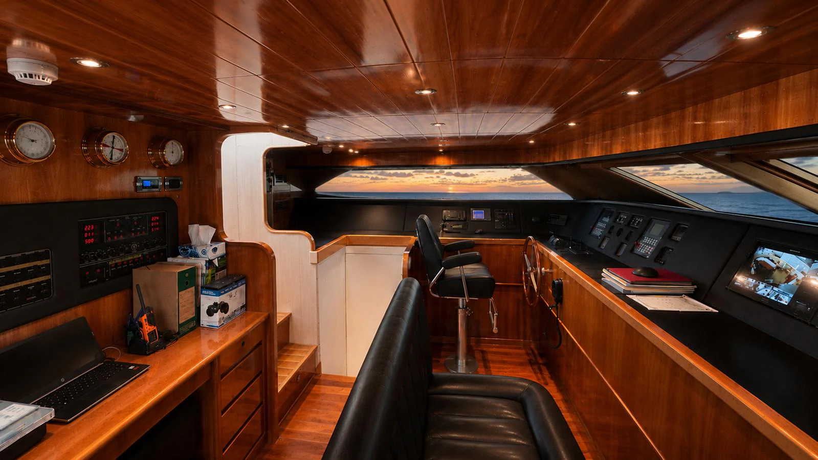 The helm station features rich wood paneling and modern navigation equipment. aboard ALPHERATZ Yacht for Sale