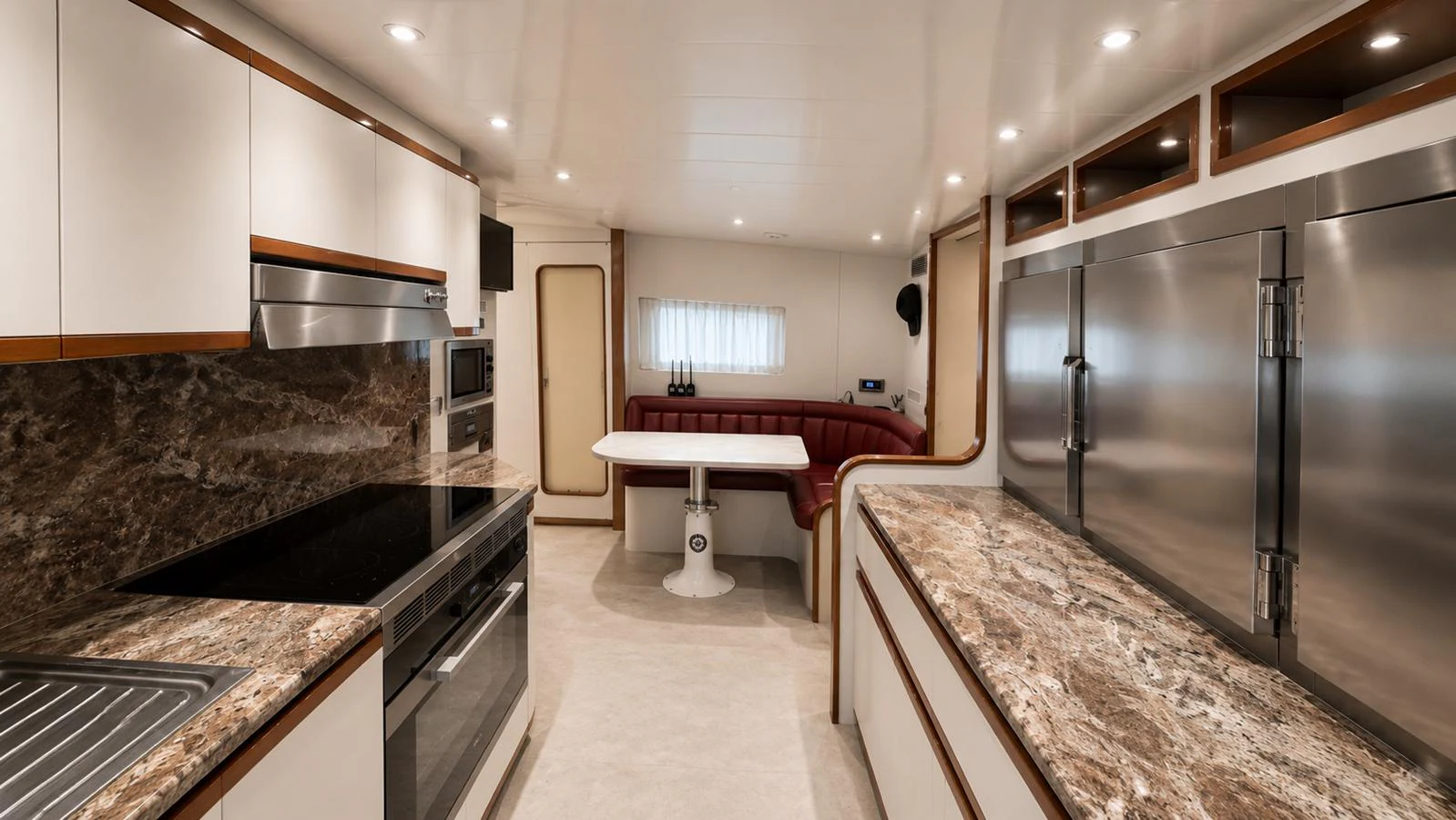 The yacht's galley features modern appliances and a cozy dining area. aboard ALPHERATZ Yacht for Sale
