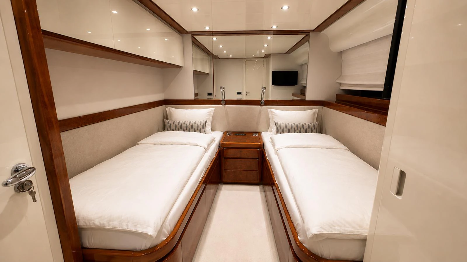 The twin stateroom offers a cozy and elegant sleeping area with two single beds and modern decor. aboard ALPHERATZ Yacht for Sale
