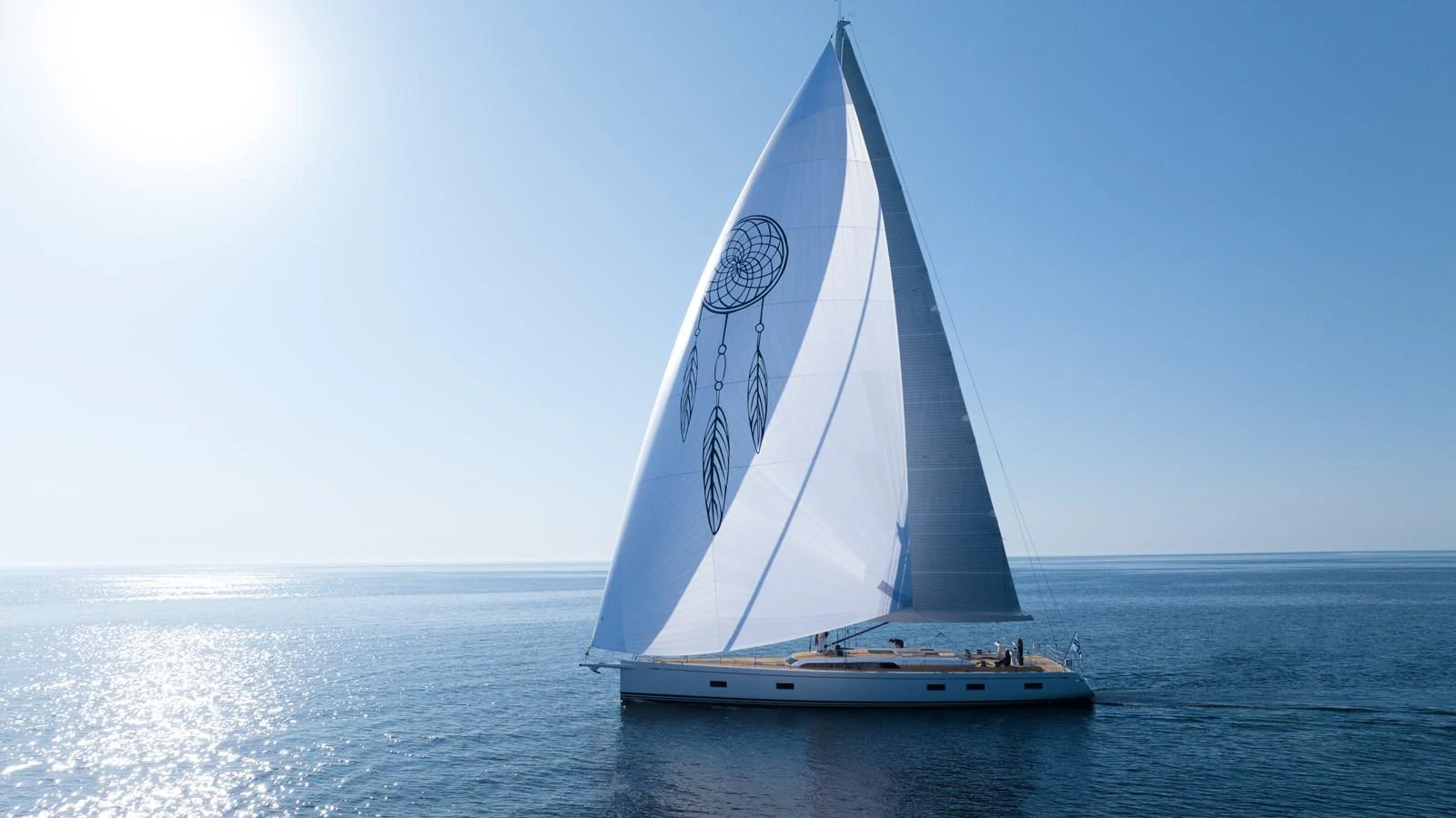 A sleek sailing yacht glides gracefully across calm waters under a clear blue sky. aboard DREAMCATCHER Yacht for Sale
