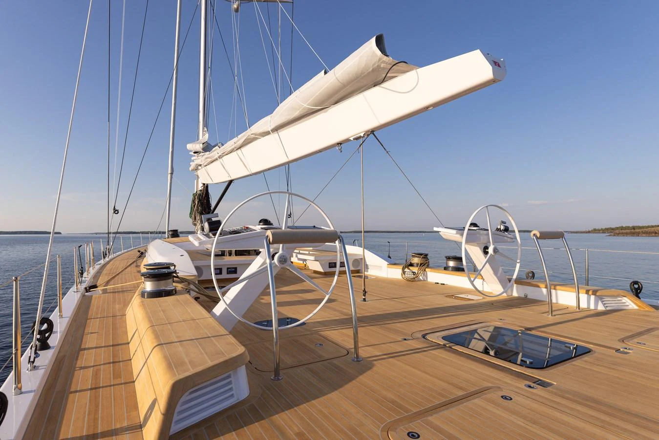 The yacht's deck features sleek lines and modern sailing equipment, set against a serene ocean backdrop. aboard DREAMCATCHER Yacht for Sale