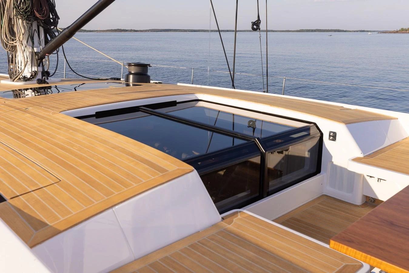 The yacht features a sleek deck with modern glass elements and elegant wooden finishes. aboard DREAMCATCHER Yacht for Sale