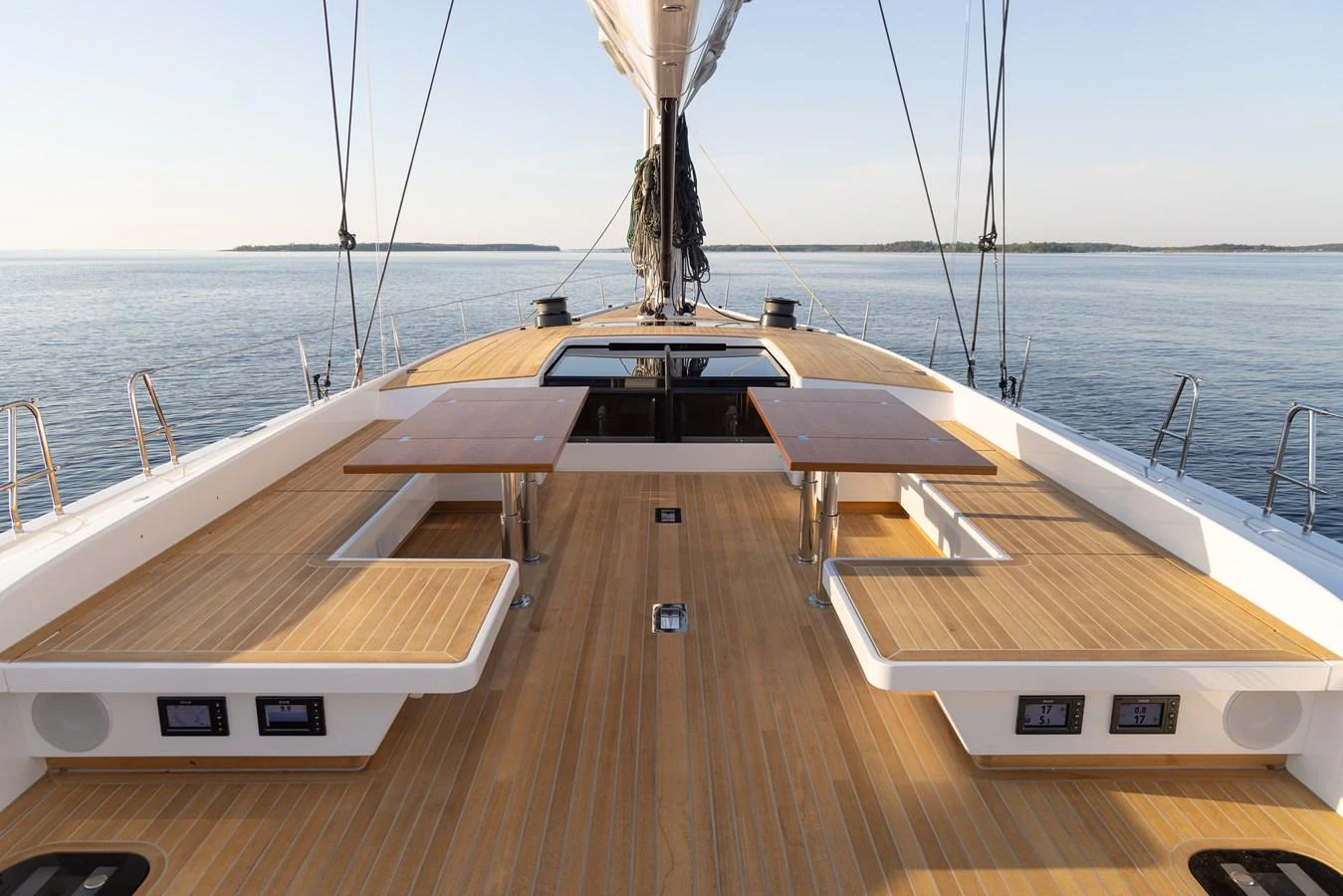 The yacht's deck features elegant wooden seating areas and tables, perfect for outdoor relaxation and dining. aboard DREAMCATCHER Yacht for Sale