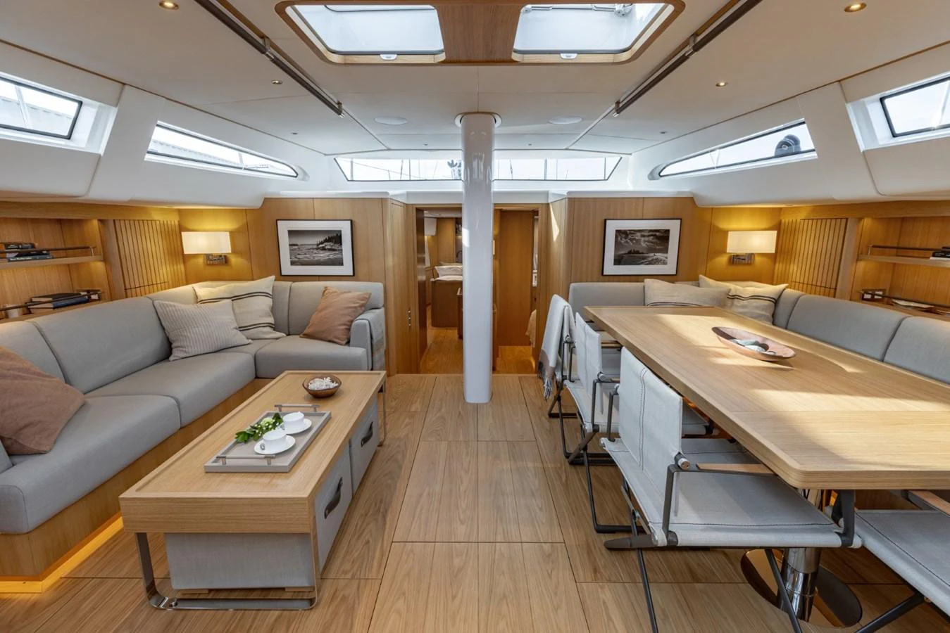 The salon features a spacious and well-lit seating area with modern furnishings and ample natural light from overhead skylights. aboard DREAMCATCHER Yacht for Sale