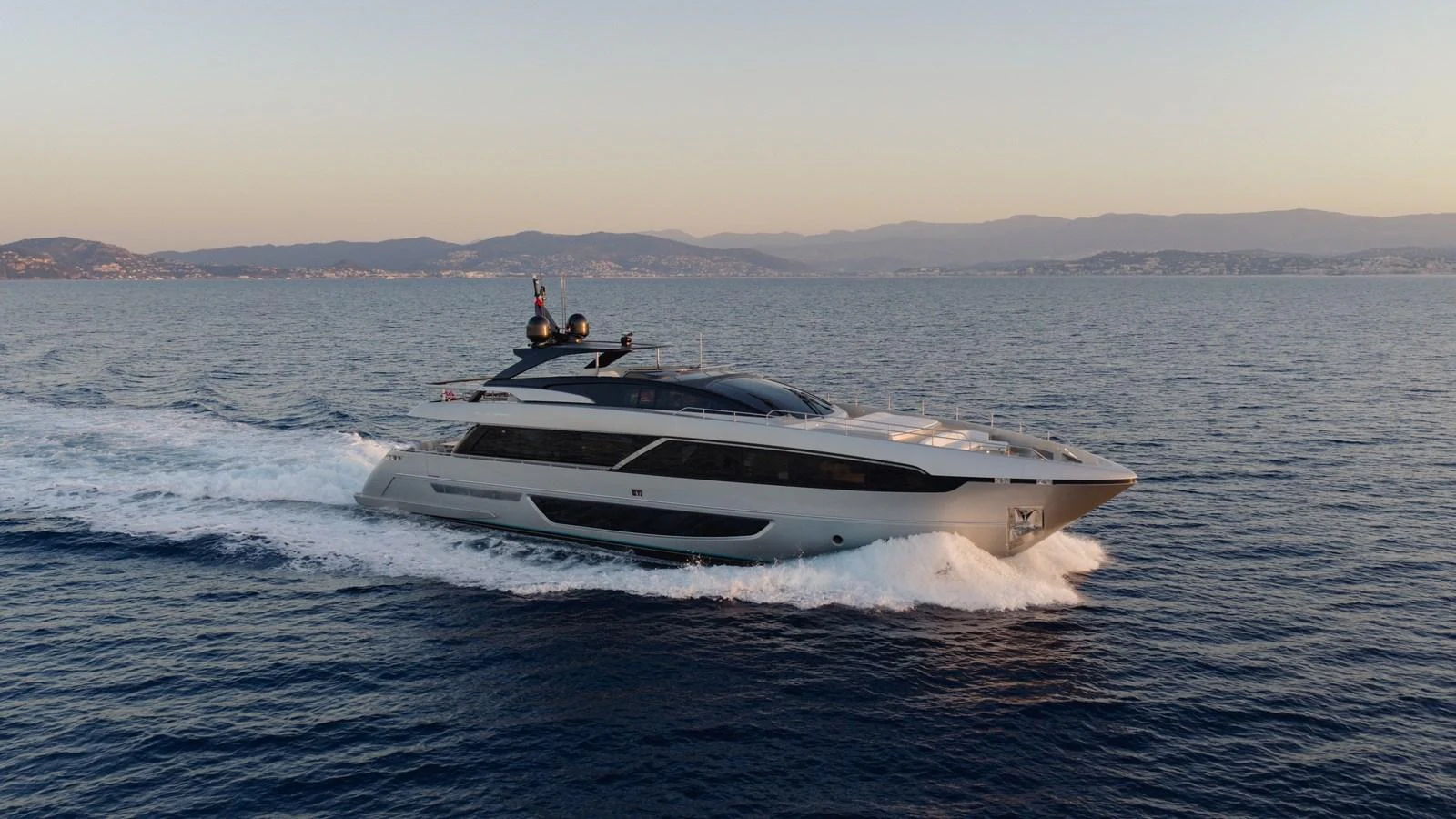 A sleek and modern yacht cruises gracefully on the open sea at sunset. aboard M Yacht for Sale