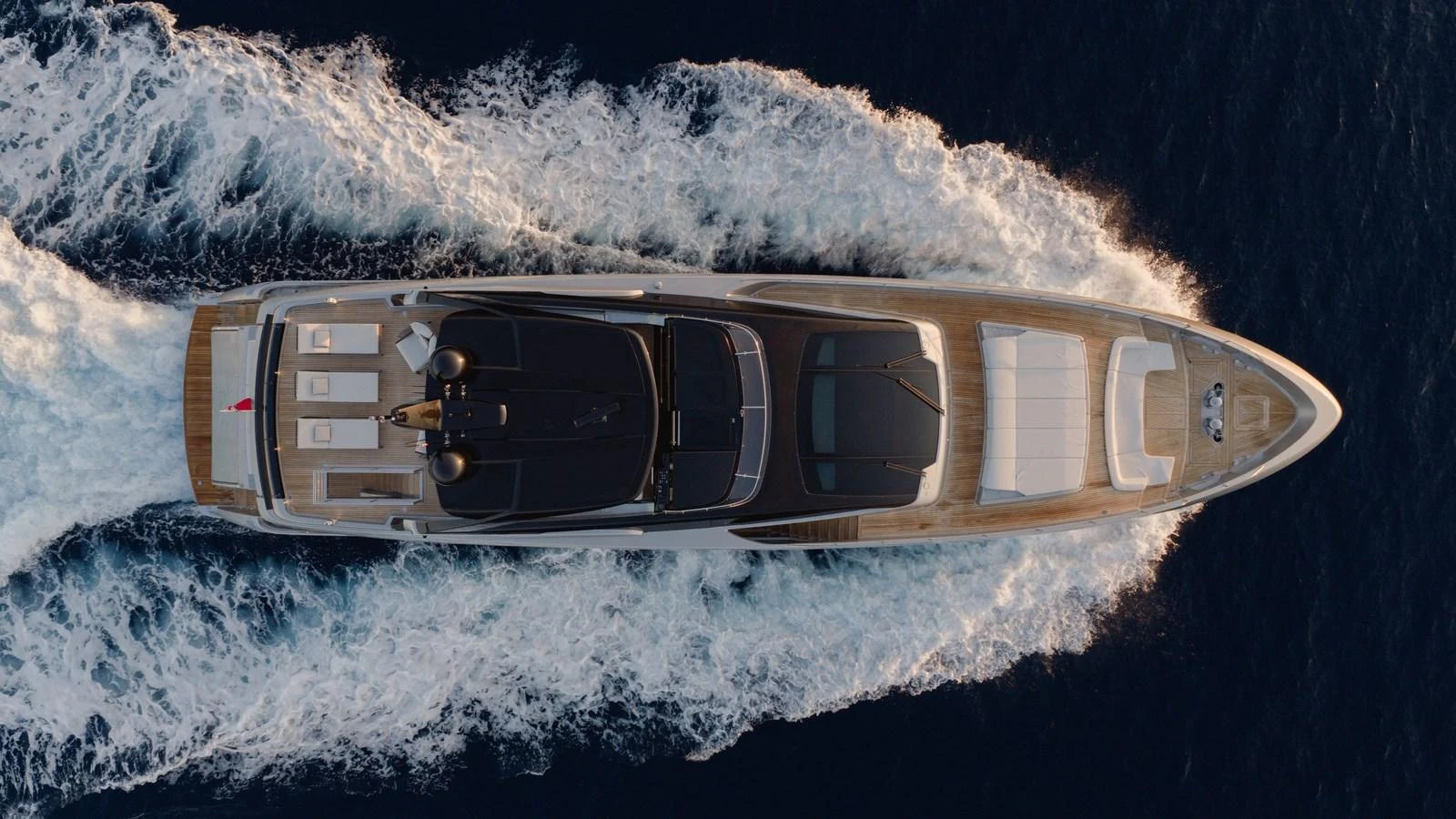 An aerial view of a sleek yacht cruising through the water, showcasing its elegant design and spacious deck areas. aboard M Yacht for Sale