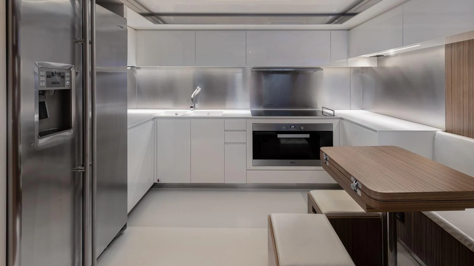 The sleek and modern galley features high-end stainless steel appliances and minimalist design. aboard M Yacht for Sale