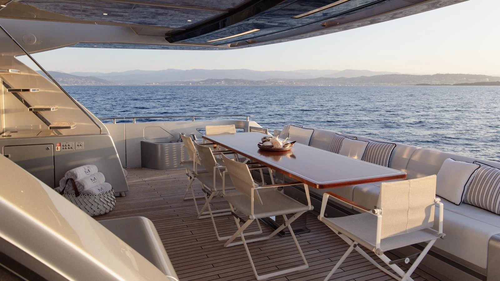 The aft deck features a spacious dining area with a stunning view of the sea. aboard M Yacht for Sale
