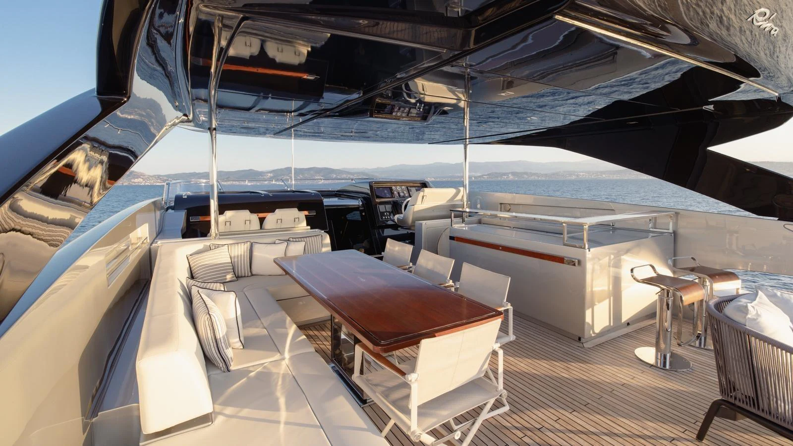 The aft deck features a spacious seating area with a dining table, perfect for alfresco dining and relaxation. aboard M Yacht for Sale