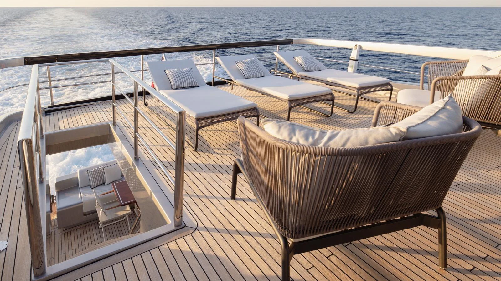 The sundeck offers luxurious lounging with sunbeds and comfortable seating, perfect for relaxation while cruising. aboard M Yacht for Sale