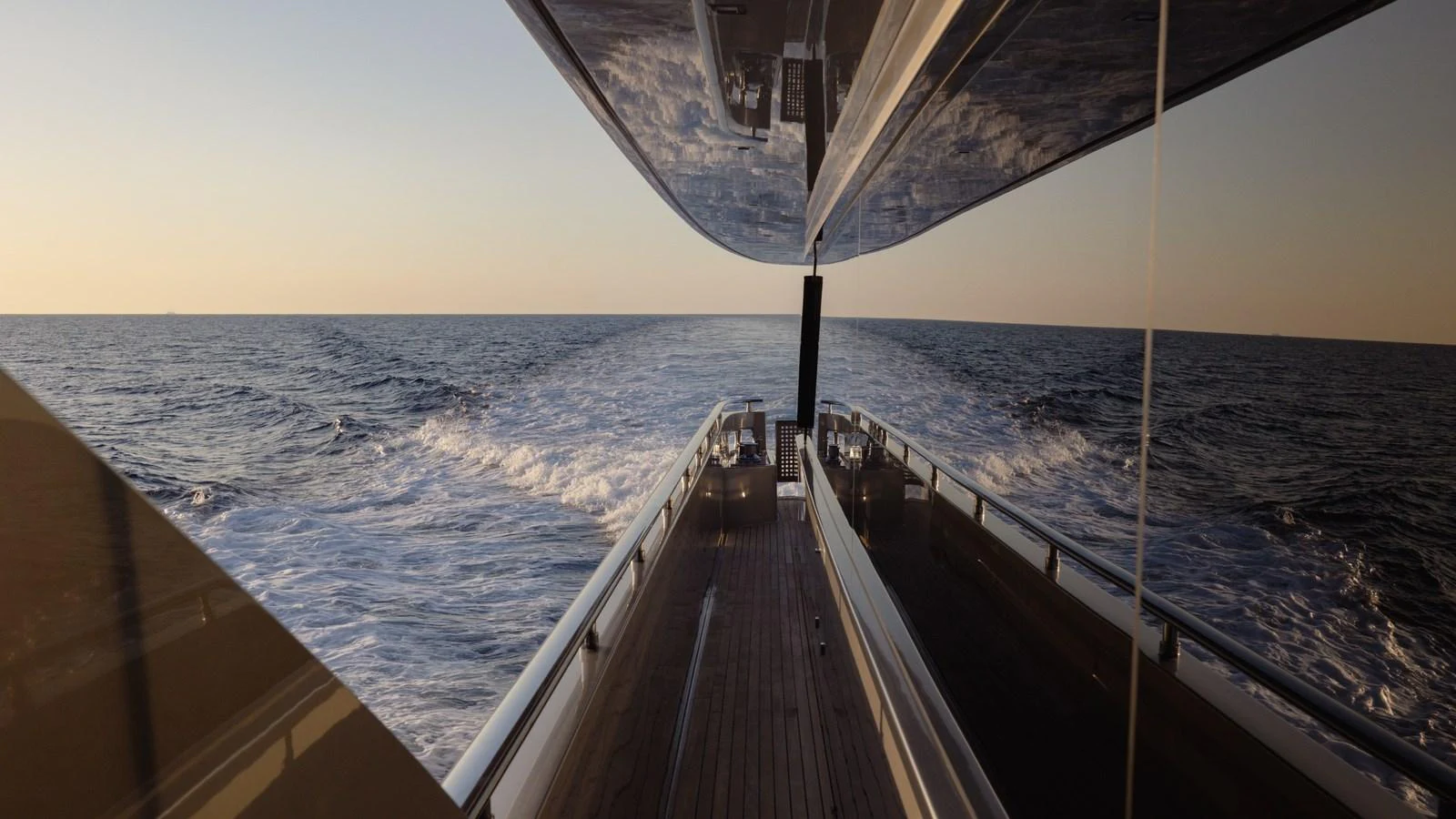 A sleek yacht cruises through the open sea, leaving a trail of waves behind. aboard M Yacht for Sale