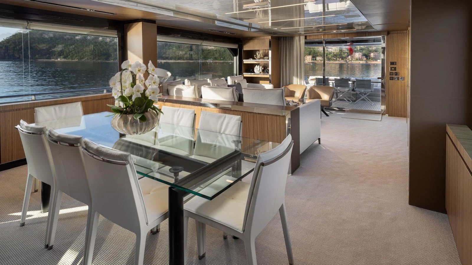 The salon features elegant dining and lounging areas with panoramic views. aboard M Yacht for Sale